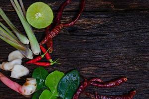 Thai ingredients for Tom yum soup on old wooden background photo