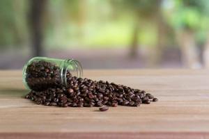 Roasted coffee beans in a glass bottle photo