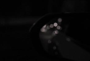 Reflection of bokeh in the side mirror of a car photo