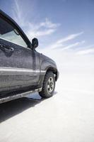 Terrain vehicle at Salar de uyuni salt flat in Bolivia photo