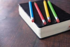 Close up of colorful pencils on a book photo
