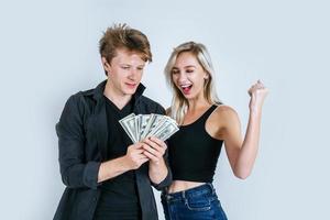 Happy couple showing dollar banknotes photo