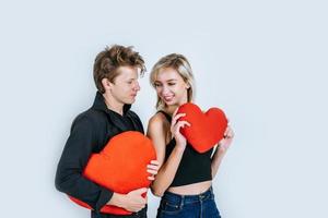 Happy couple loving together holding a red heart