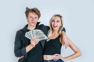 Happy couple showing dollar banknotes photo