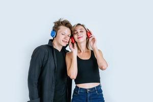 Happy young couple in headphones listening music in studio photo