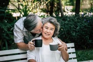 Elderly couples playing and drinking coffee photo