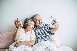 Elderly couple using a smartphone photo