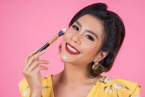 Portrait of a woman with makeup brush photo