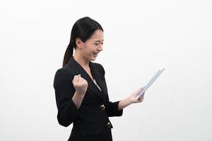 Smiling young business woman uses a tablet PC isolated on white background. photo