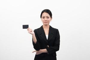 Portrait of young smiling Asian businesswoman holding empty credit card photo