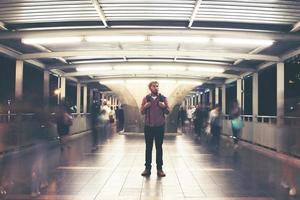 Handsome bearded man with backpack standing on the street traveling at night photo