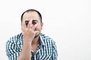 Man covering his face isolated on white background. photo