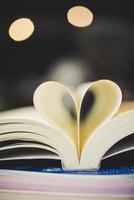 Curled paper heart shape with blurred bokeh of cafe photo