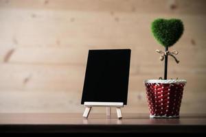 Blank blackboard, tree of heart on wood background, with copy space photo