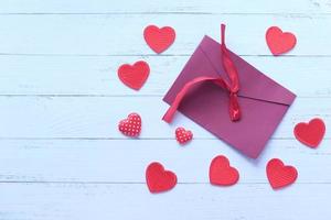 Red envelope and red heart on white background photo