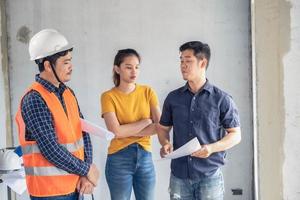 Young Asian engineers building a house photo