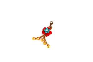 Key chain red flowers with a golden bell photo