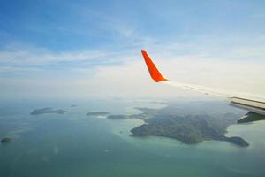 Aerial view of plane wing over Phucket Island, Thailand photo