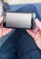 Close up of a man holding a mobile smartphone photo