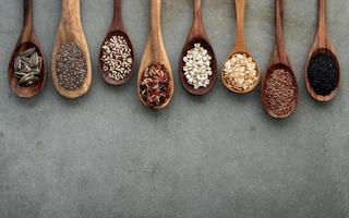 Spoons of grains on concrete photo