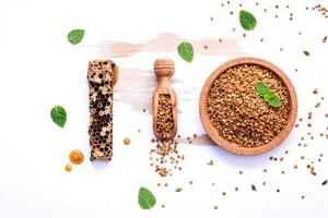 Raw organic bee pollen on shabby wooden board photo