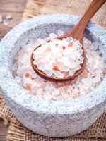 Himalayan sea salt in a mortar and a spoon photo