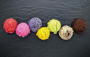 Colorful scoops of ice cream on slate photo