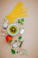 Spaghetti ingredients on a brown background photo