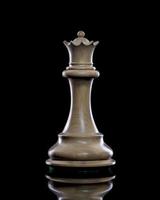 White queen chess piece on a dark background photo