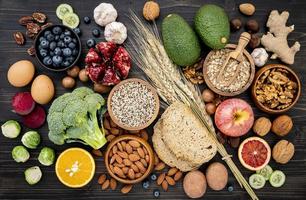 Top view of healthy foods on a dark wood background photo