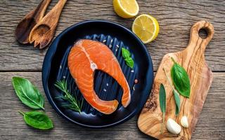 Salmon fillet with fresh herbs and lemon photo