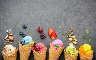 Ice cream in cones with fresh fruit and nuts photo