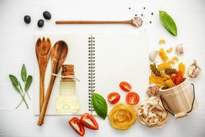 Open notebook with Italian ingredients photo