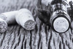 Black and white photo of a wine bottle and corks