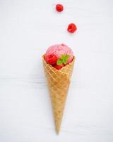 Raspberry ice cream in a cone photo