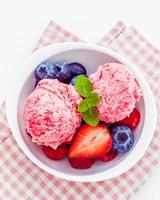 Top view of raspberry ice cream with mixed berries photo