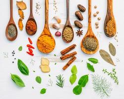 Herbs and spices on a shabby white background photo