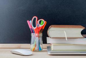 Books and supplies on a desk photo