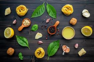 Fresh pasta ingredients on dark wood photo