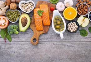 Salmon and other fresh foods on a rustic wood background photo