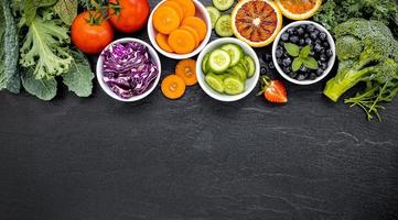 Bowls of fruit and veggies with copy space photo