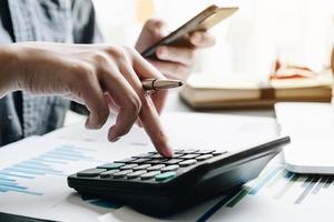 Close up of businessman using a calculator photo