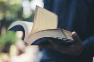 Close-up of woman's hands holding a book reading photo