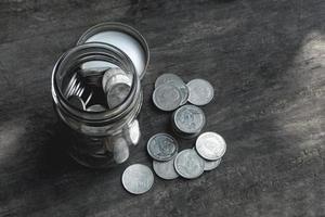 Money saving coins in a glass bottle with filter effect photo