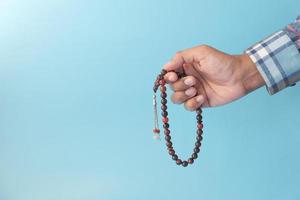 Prayer beads on blue background