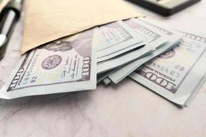 Close up of cash in a envelope on table photo