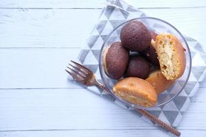 Indian sweets in a bowl on white table with copy space photo