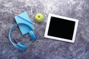 Headphones and digital tablet on table photo