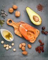 Salmon fillet and fresh ingredients on a dark background photo