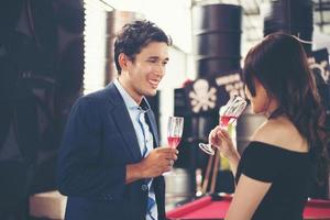 Young business couple with glasses of champagne photo